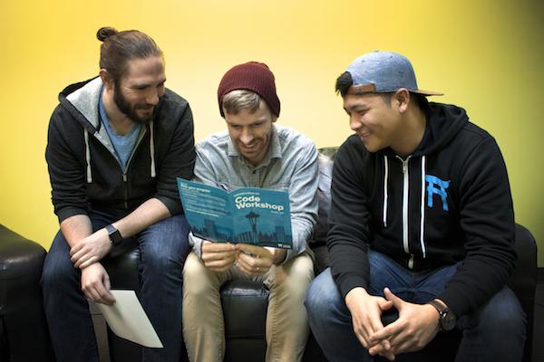 Three coders on a laptop