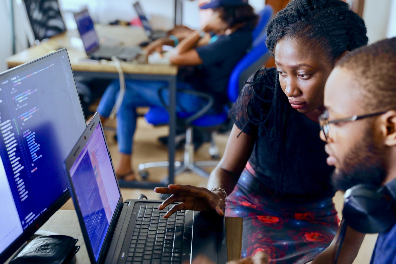 Instructer helping student at a coding bootcamp