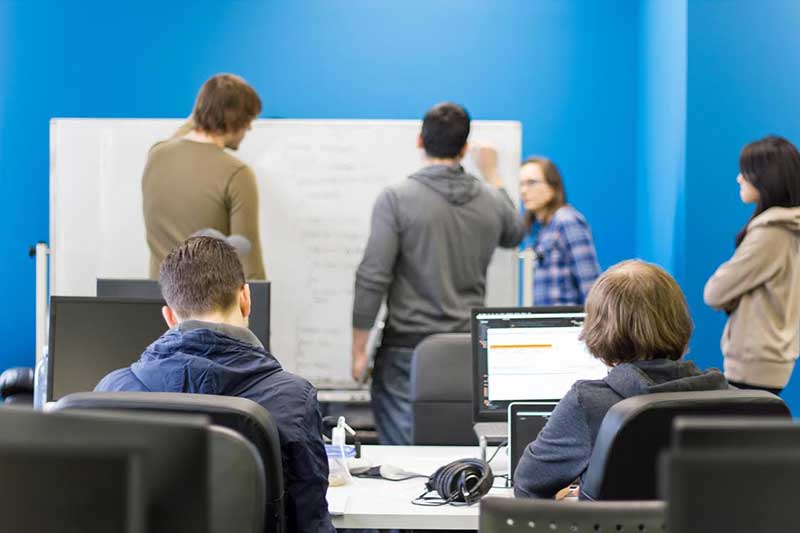 Students and an instructor at a Coding Dojo bootcamp