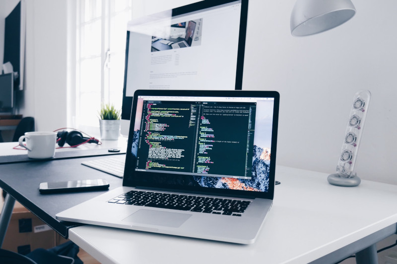 Laptop with code sitting on a desk