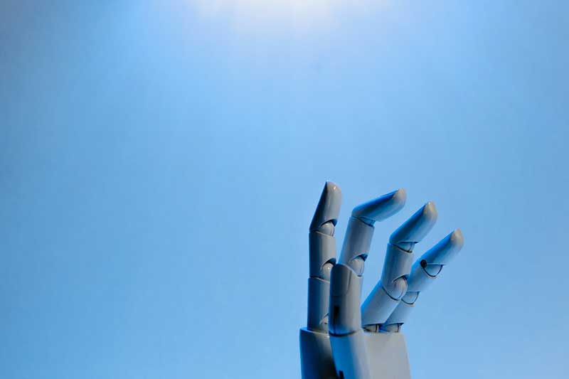 A robot hand reaching in the sky