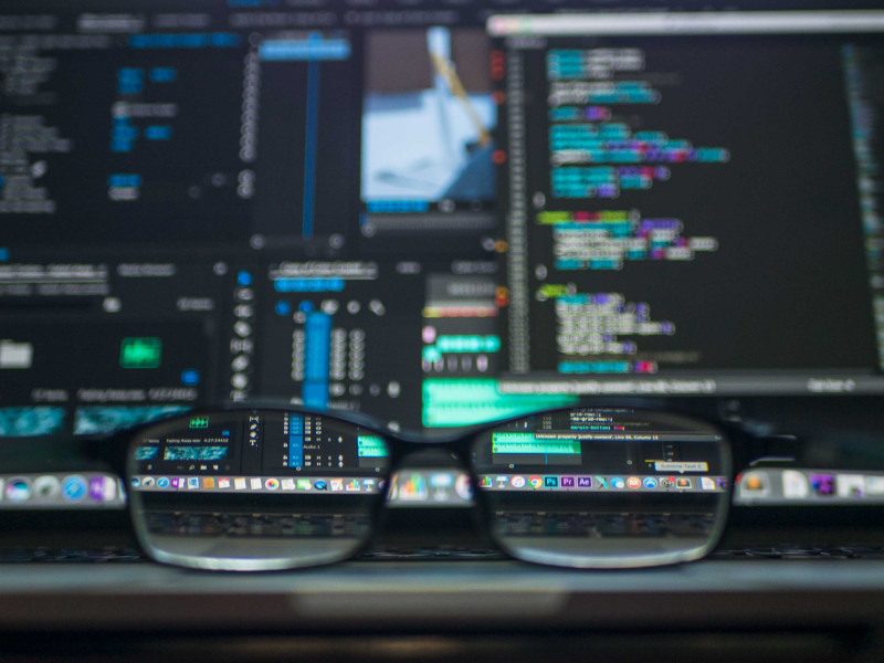 Glasses in front of computer screen showing code