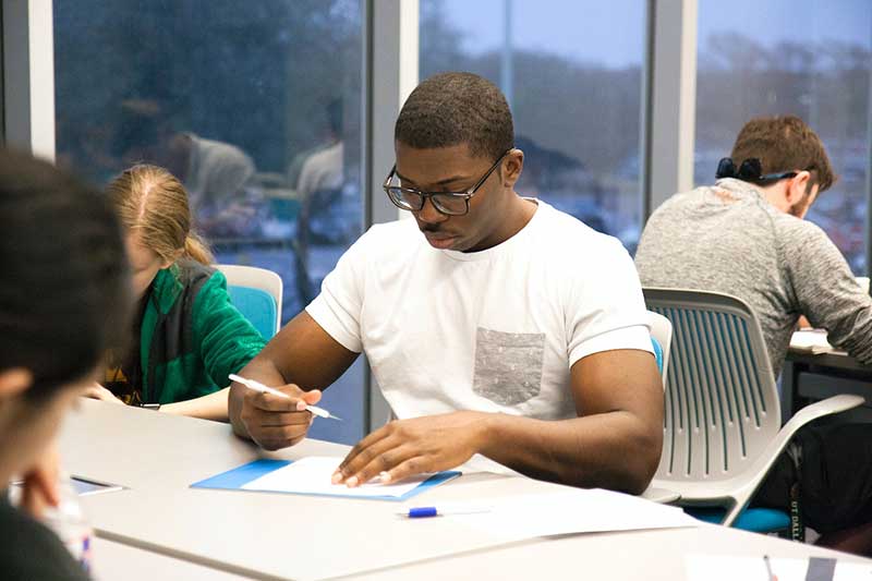 Students taking an exam in a classroom setting