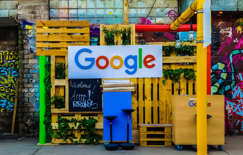 Google sign on a colorful street