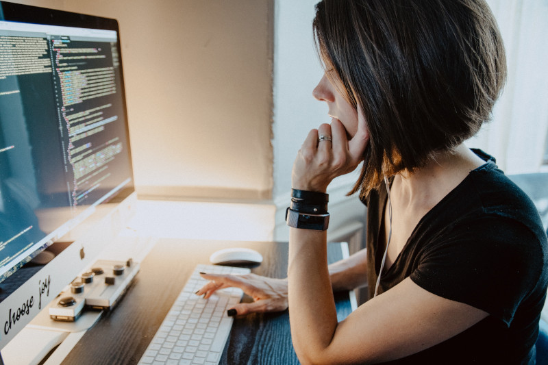 Woman coding at computer