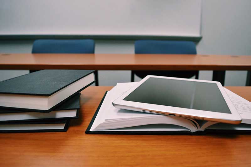 Books on a desk in a classroom
