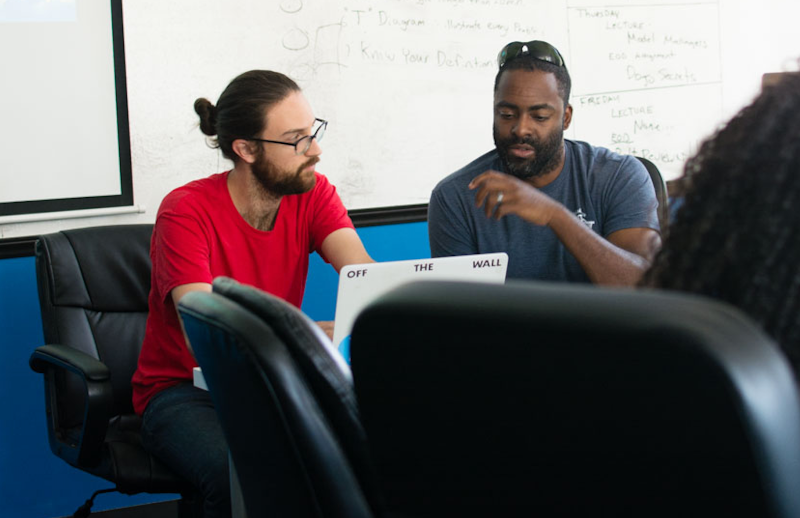 Instructor and student in a coding bootcamp