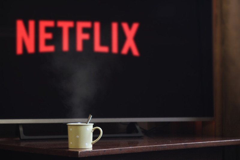 Mug of coffee and TV with Netflix
