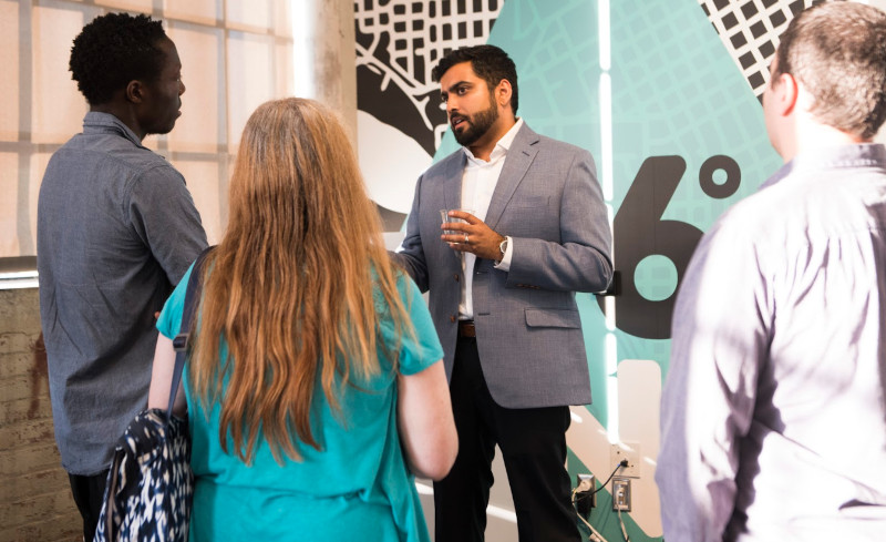 Man talking to students at an open house