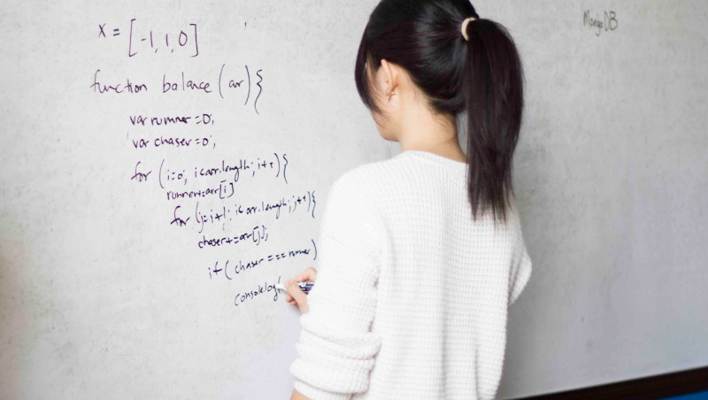 Woman writing on a whiteboard