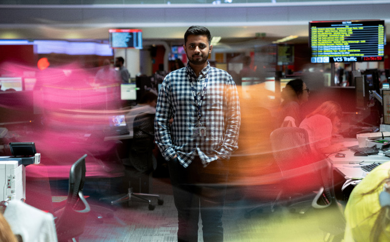 Man standing in a fast-paced office